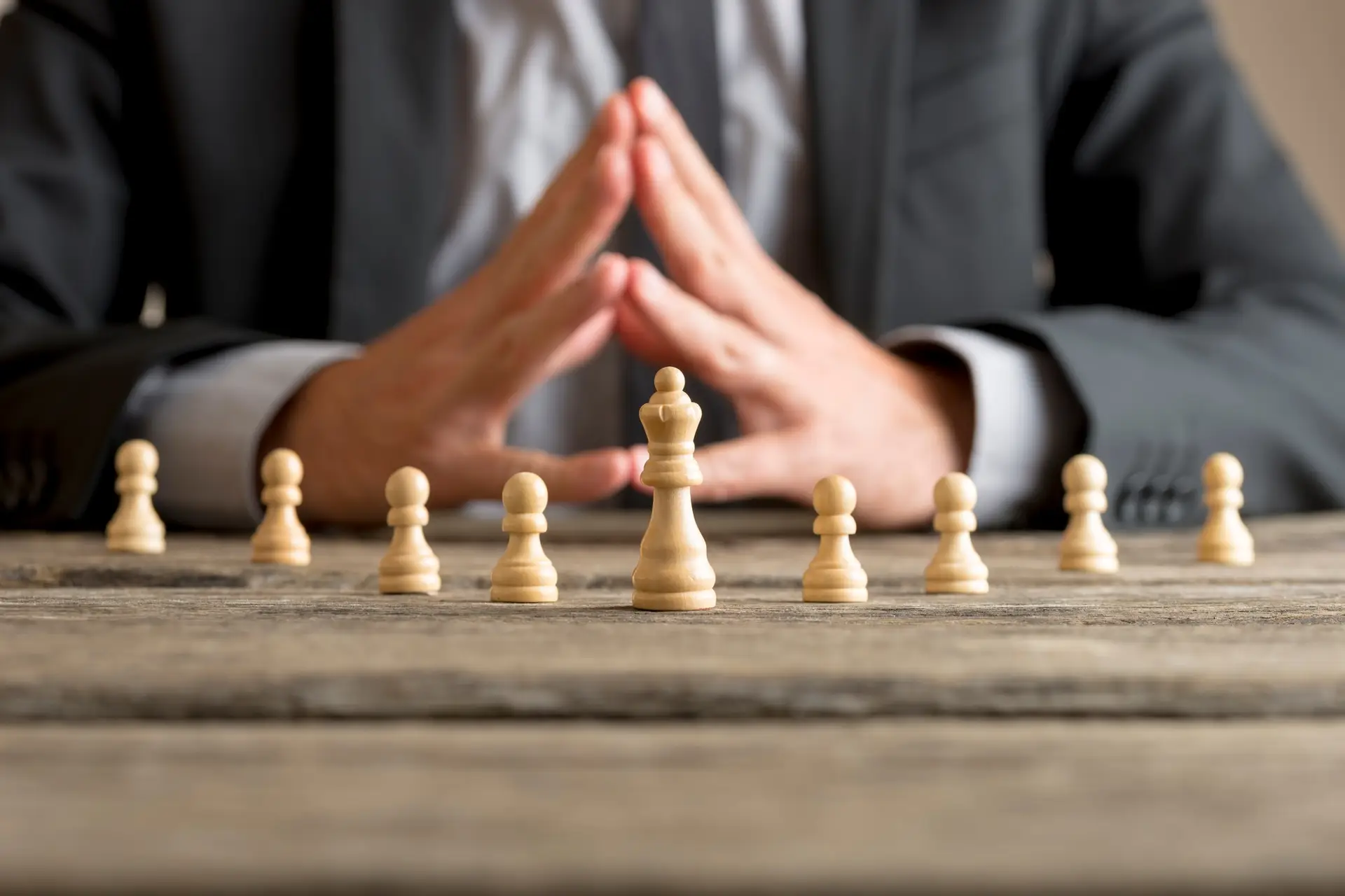 Businessman with clasped hands planning strategy