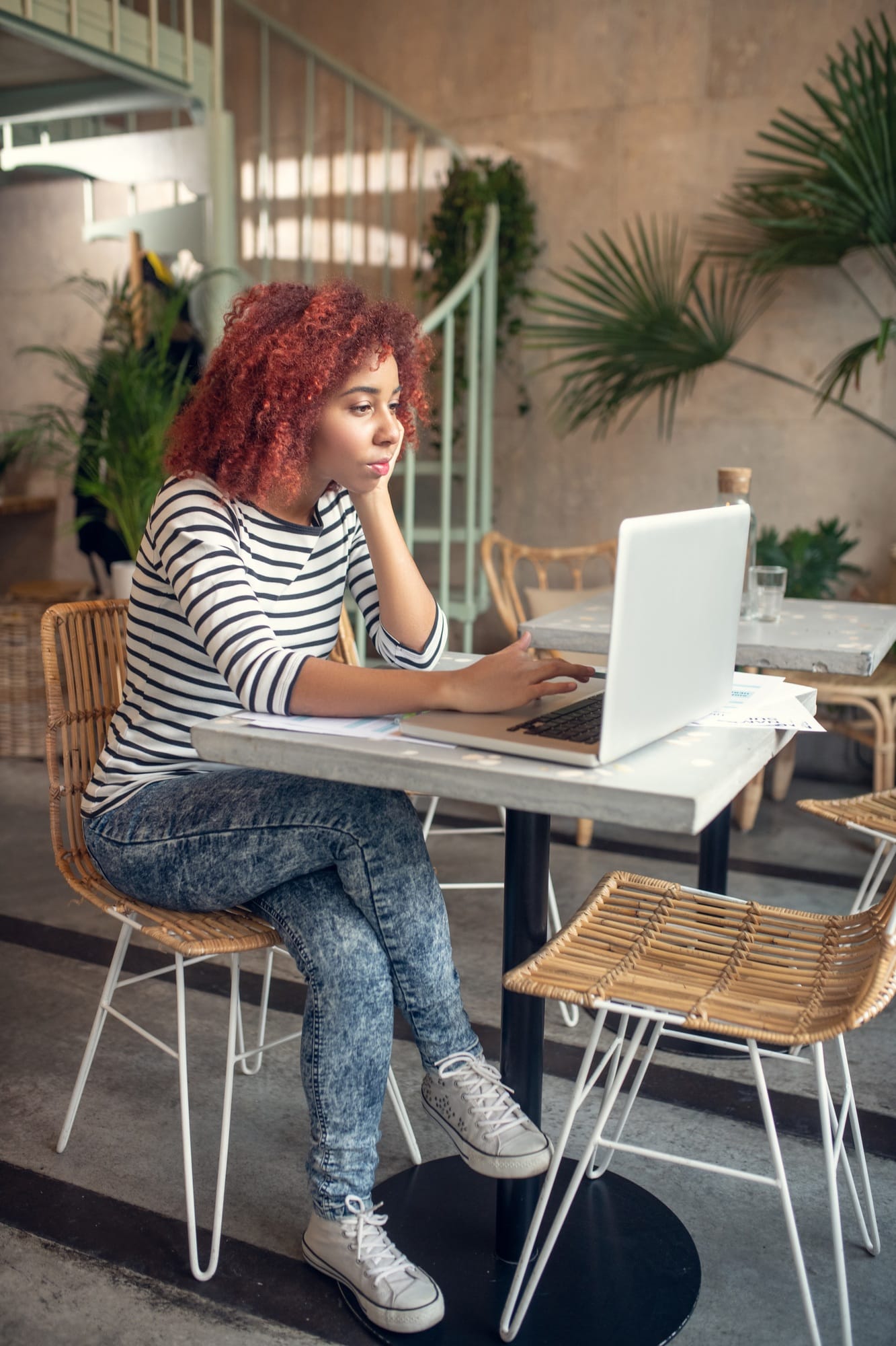 Young cute businesswoman reading e-mail from investor