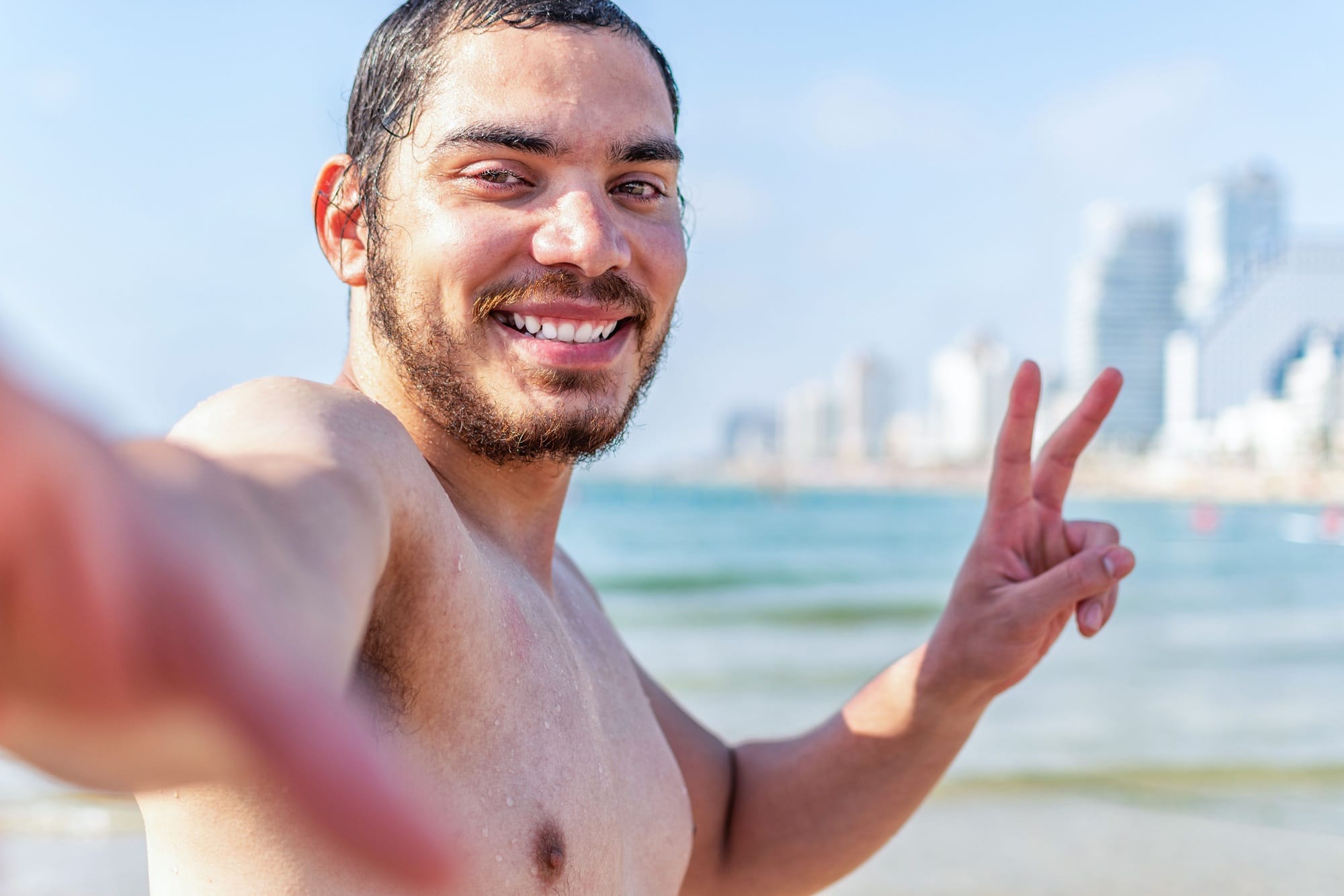 Israeli man taking a selfie at the beach on a summer holiday